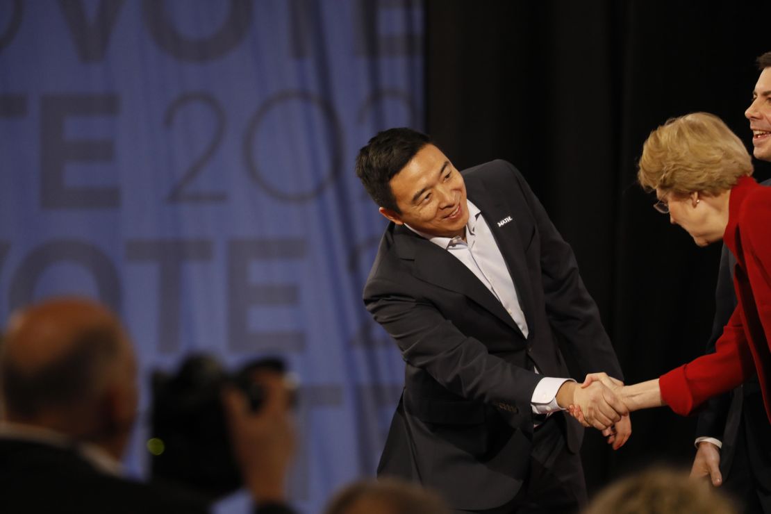 Andrew Yang shakes hands with Elizabeth Warren before the Democratic debate in Los Angeles on Thursday, December 19.