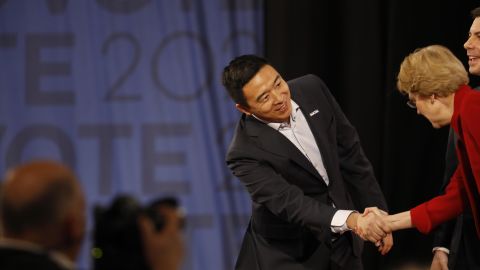 Andrew Yang shakes hands with Elizabeth Warren before the Democratic debate in Los Angeles on Thursday, December 19.