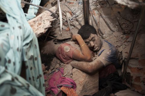 Two victims are seen in the rubble after <a href="https://www.cnn.com/2013/10/24/opinion/bangladesh-garment-workers/index.html" target="_blank">an eight-story building collapsed</a> in Savar, Bangladesh, in April 2013. More than 1,000 people were killed.