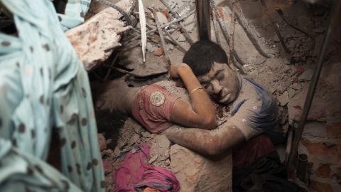 Two victims are seen in the rubble after <a href="https://www.cnn.com/2013/10/24/opinion/bangladesh-garment-workers/index.html" target="_blank">an eight-story building collapsed</a> in Savar, Bangladesh, in April 2013. More than 1,000 people were killed.