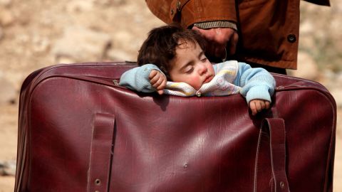 A child sleeps in a bag in the Syrian village of Beit Sawa in March 2018.