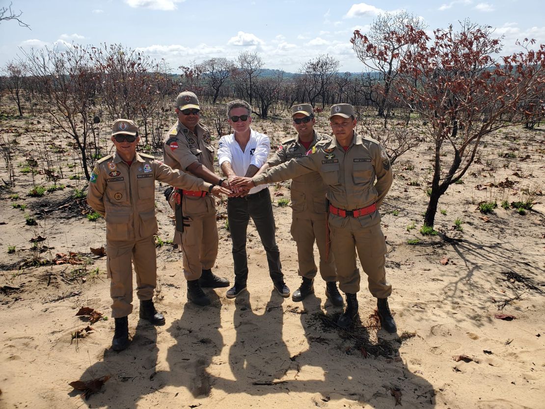 Extreme E founder Alejandro Agag (central) with soldiers in a deforested region of the Amazon.