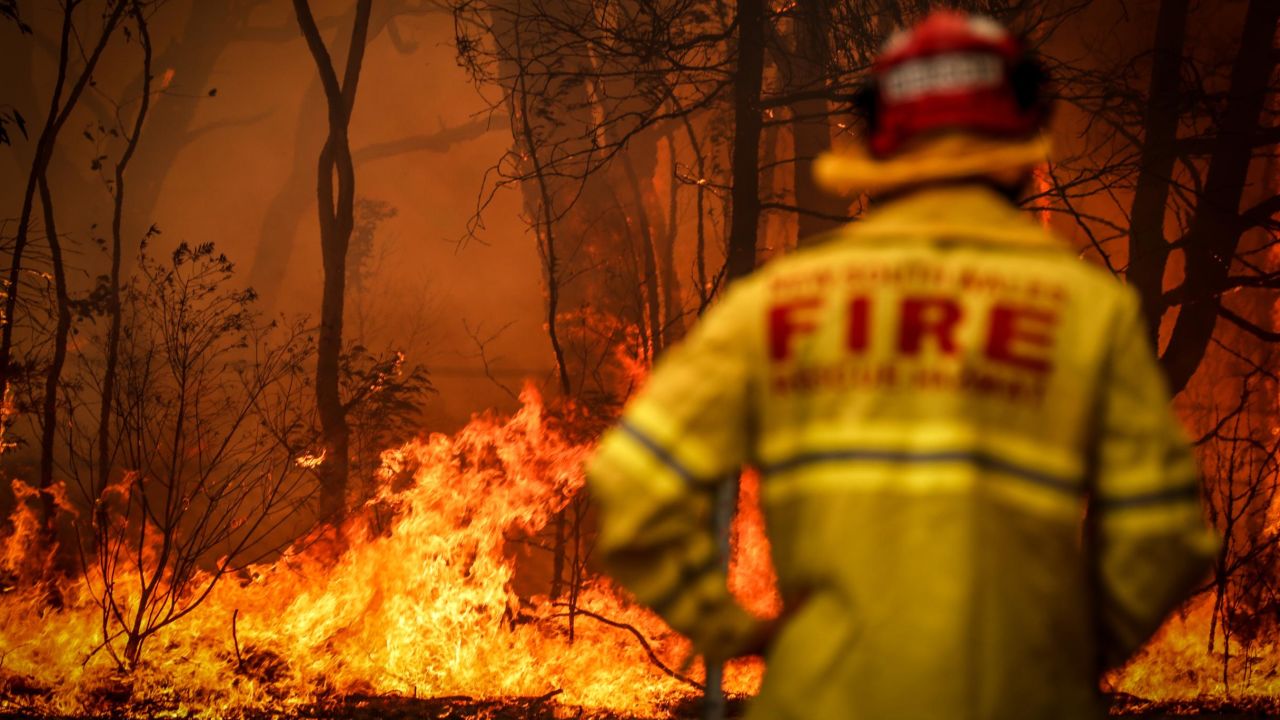  A Fire and Rescue personal watches a bushfire as it burns near homes on the outskirts of the town of Bilpin on December 19, 2019 in Sydney, Australia.