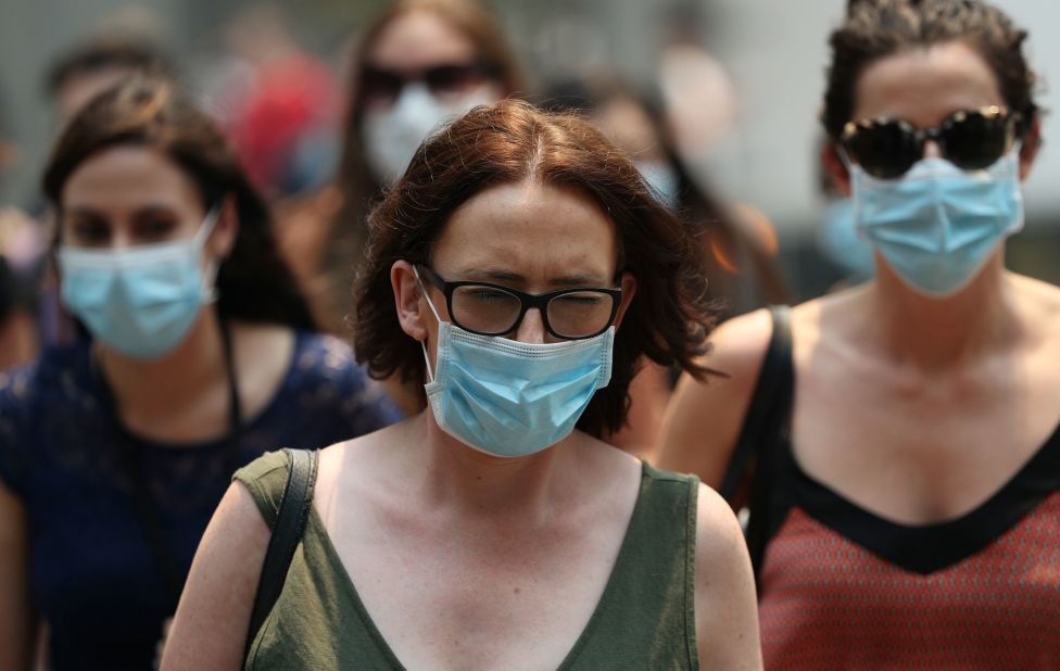 People are seen wearing face masks to protect against the poor air quality in Sydney on December 5.