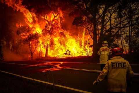 Fire and rescue personnel monitor a bushfire as it burns near homes on the outskirts of Bilpin on Thursday, December 19.