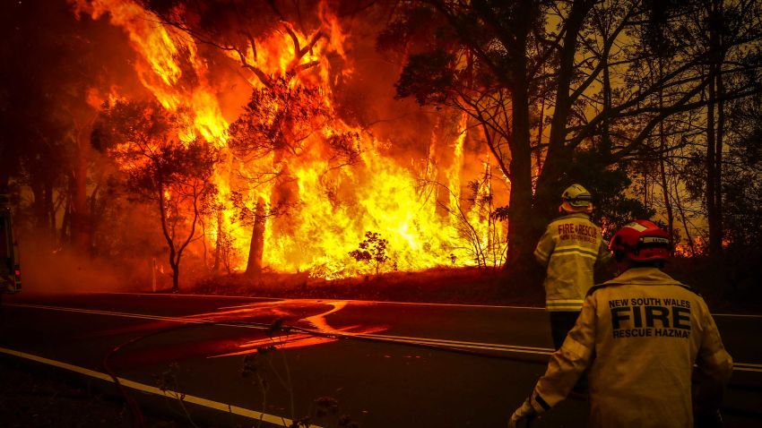 SYDNEY, AUSTRALIA - DECEMBER 19: Fire and Rescue personal watch a bushfire as it burns near homes on the outskirts of the town of Bilpin on December 19, 2019 in Sydney, Australia.   (Photo by David Gray/Getty Images)