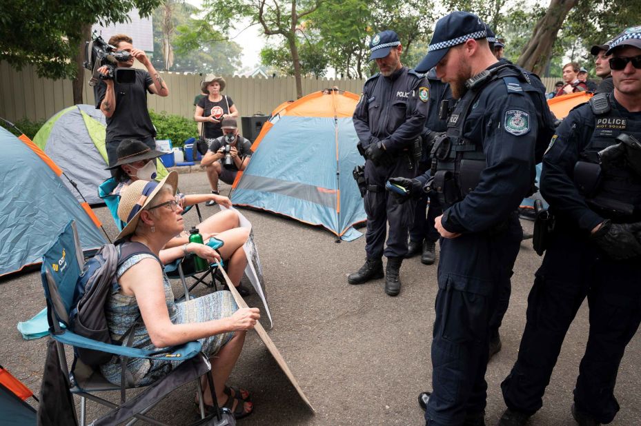 Police disperse demonstrators during a climate protest near Australian Prime Minister Scott Morrison's official residence in Sydney, on December 19, during his absence on an overseas holiday, as bushfires burned across the region.