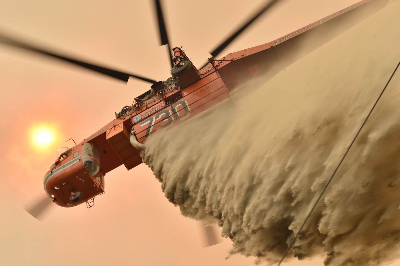 A helicopter drops fire-retardant to protect a property in Balmoral.