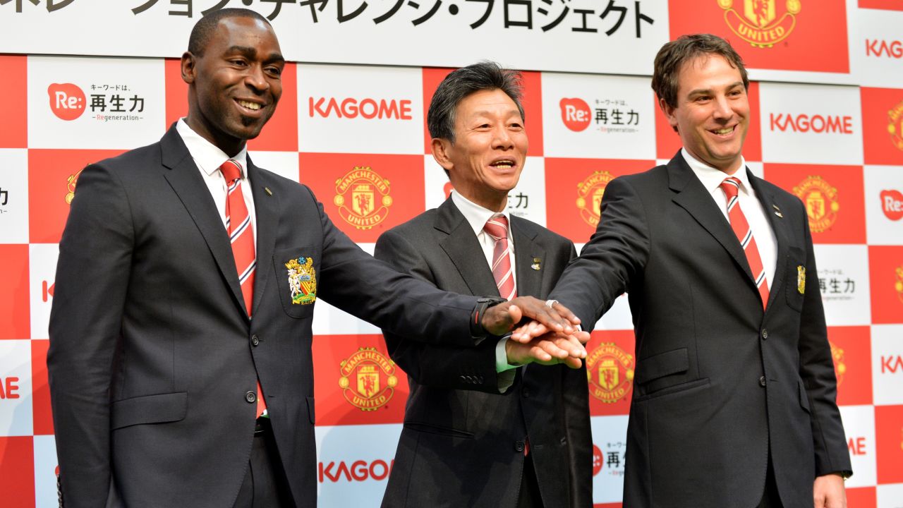 Reigle (right) poses with former Manchester United forward Andy Cole (left) and president of Japanese food company Kagome, Hidenori Nishi (center) in Tokyo.