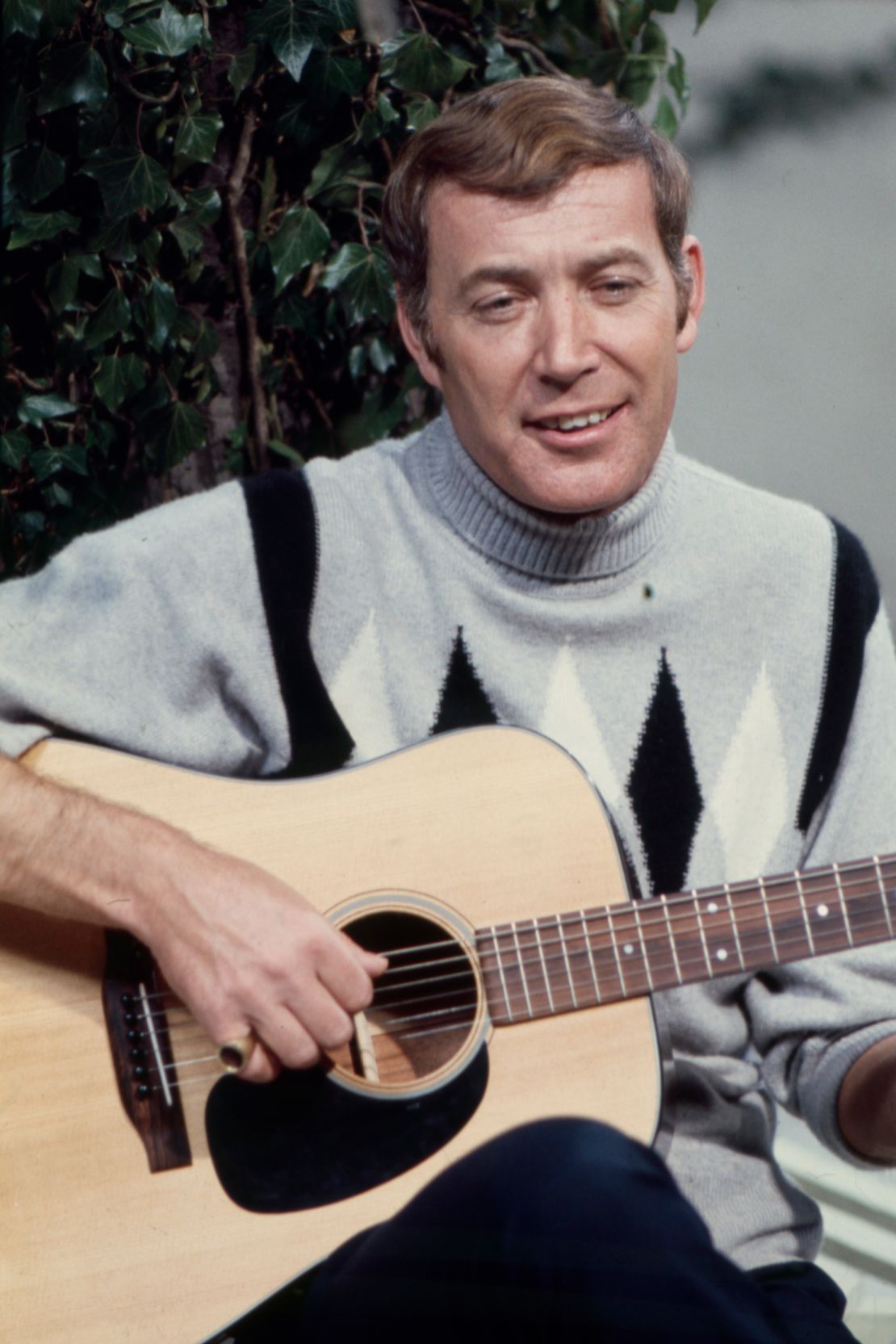 Val Doonican performing in a festive sweater on an episode of his ABC series "The Val Doonican Show" in 1971.