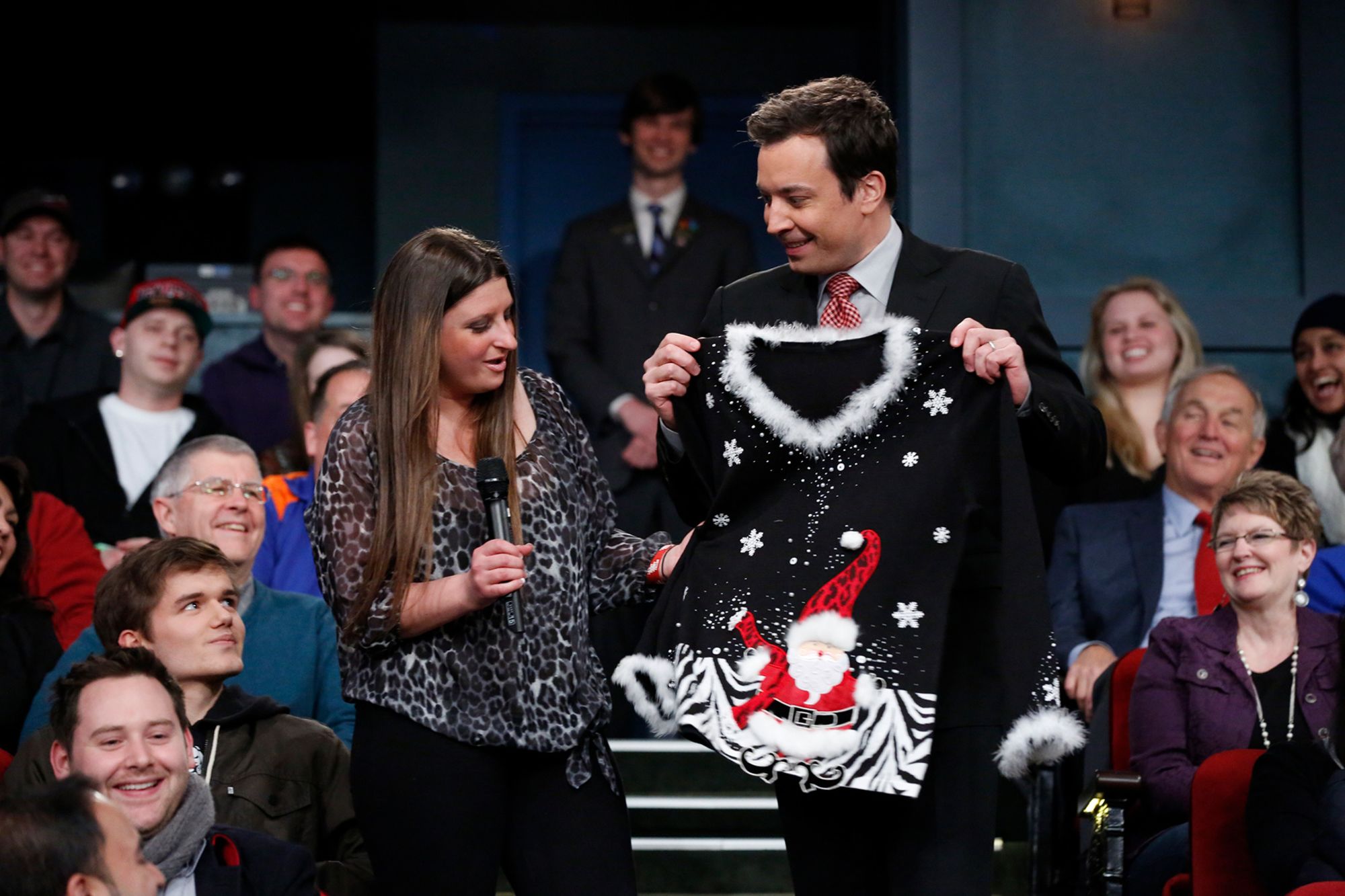 "The Tonight Show” host Jimmy Fallon gives away a festive Christmas sweater to an audience member in 2013.