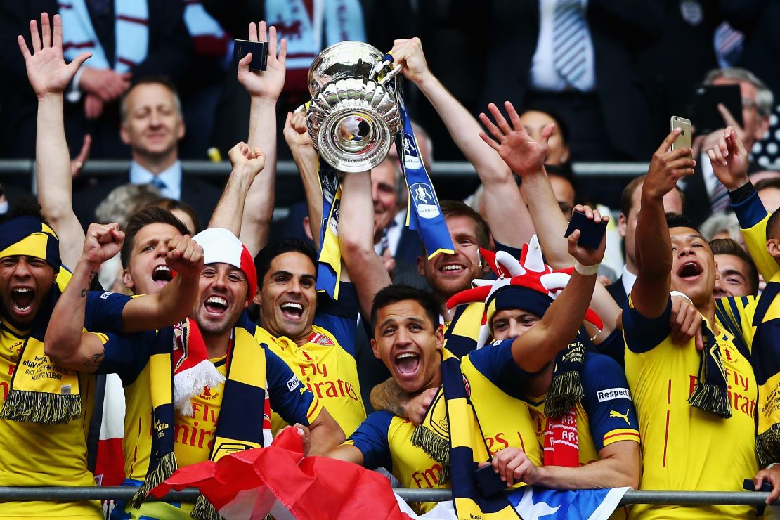 Mikel Arteta lifts the FA Cup as Arsenal captain alongside Per Mertesacker.