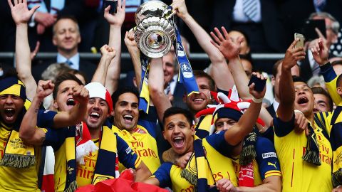 Mikel Arteta lifts the FA Cup as Arsenal captain alongside Per Mertesacker.