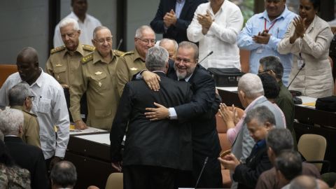 Manuel Marrero Cruz (facing camera) embraces Cuban President Miguel Diaz-Canel during the closing session at the National Assembly in Havana, Cuba, on Saturday.