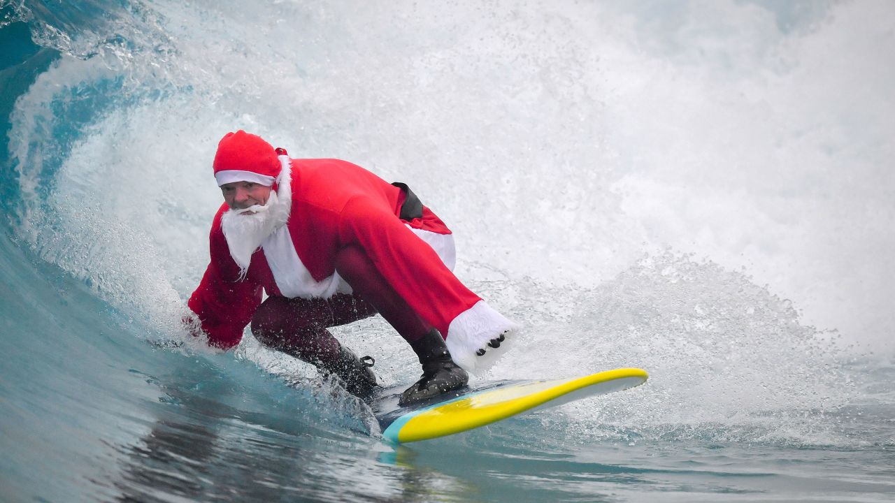 Father Christmas, as Santa Claus is known to Australian kids, is sometimes known surf in on Christmas day at the beach.