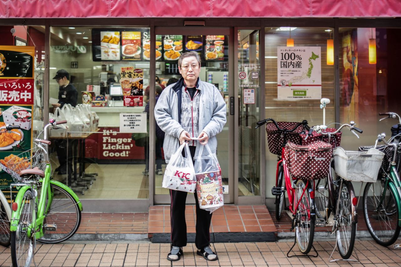 A Japanese man, photographed in 2015, poses after buying KFC for his family on Christmas Eve in Tokyo.  