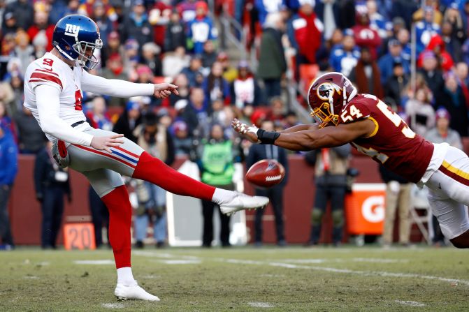 Washington Redskins' Nate Orchard blocks a punt attempt by New York Giants punter Riley Dixon on Sunday, December 22, in Landover, Maryland. 