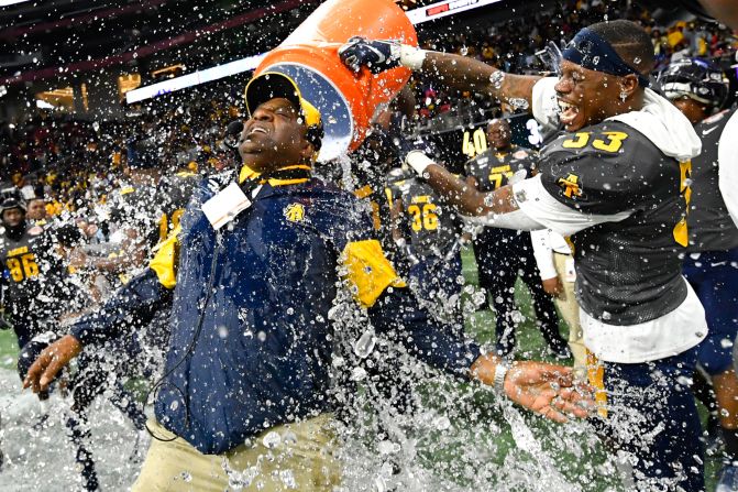 North Carolina A&T Aggies coach Sam Washington gets doused by defensive back Jalon Bethea right before winning the Celebration Bowl against Alcorn State on Saturday, December 21, in Atlanta. 