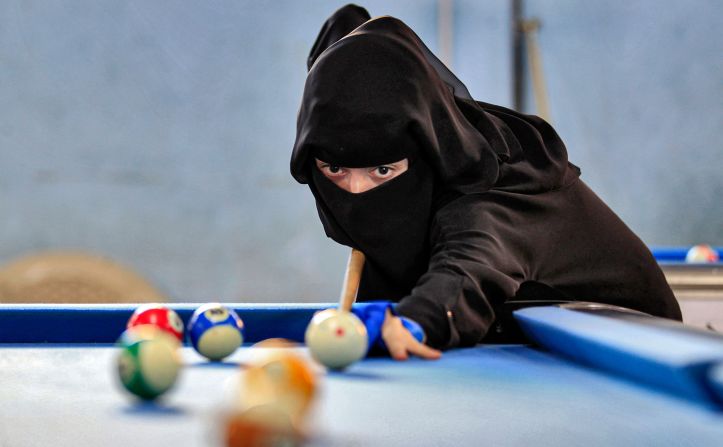 A woman plays billiards during a local championship on Monday, December 16, in Sanaa, Yemen. 