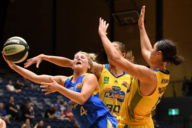 Bendigo Spirit's Shyla Heal attempts a shot despite coverage from Sydney Uni Flames Jessica Kuster and Alice Kunek during the round 10 match of the Women's National Basketball League on Thursday, December 19. 