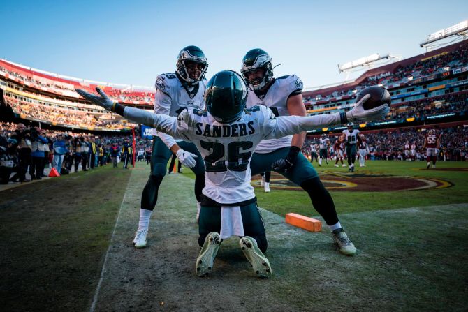 Miles Sanders of the Philadelphia Eagles, center, celebrates with teammates J.J. Arcega-Whiteside, left, and Dallas Goedert after catching a touchdown pass in the second-half an NFL game against the Washington Redskins in Landover, Maryland, on December 15.