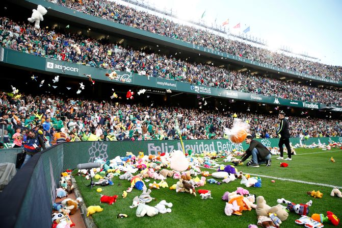 Soccer fans throw toys for charity on the field during a game between Real Betis and Atletico Madrid at Benito Villamarín Stadium in Seville, Spain, on Sunday, December 22. 