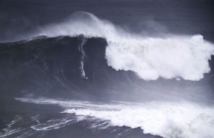 Caio Vaz of Brazil rides a wave in Nazare, Portugal, on Monday, December 16.