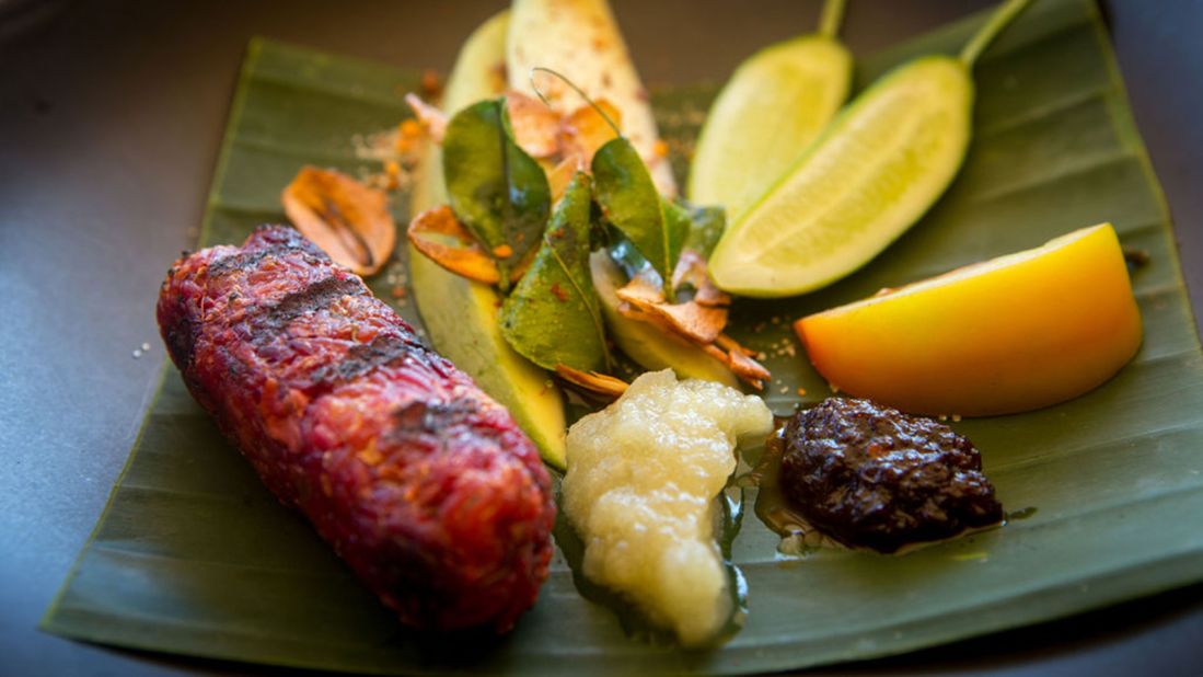 <strong>Colours of the Garden at Soneva Kiri, Thailand: </strong><br />The menu consists of seven plant-based dishes that celebrate organic fruit, vegetables and herbs. Pictured here is a deconstructed dish comprised of betroot jerky, sticky rice, sour mango and crispy garlic. <br />