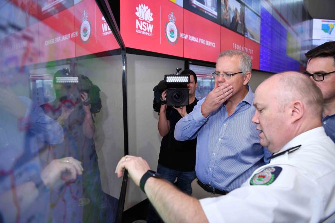Australian Prime Minister Scott Morrison is briefed by fire officials at New South Wales Rural Fire Service control room in Sydney on December 22. Morrison arrived back in Sydney <a href="index.php?page=&url=https%3A%2F%2Fedition.cnn.com%2F2019%2F12%2F22%2Fasia%2Faustralia-fire-prime-minister-criticism-apology%2Findex.html" target="_blank">amid criticism after taking a family holiday to Hawaii during the bushfire emergency.</a>
