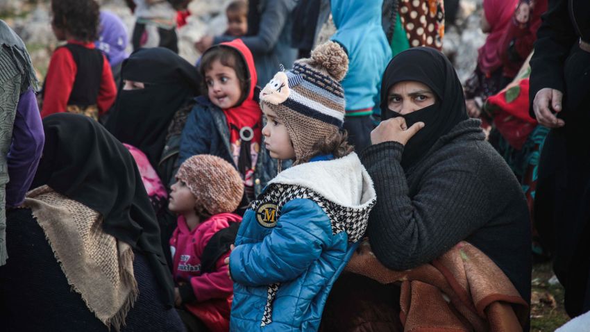Displaced Syrians from the south of Idlib province queue to receive food aid from a truck in the countryside west of the town of Dana in the northwestern Syrian region on December 23, 2019. (Photo by Aaref WATAD / AFP) (Photo by AAREF WATAD/AFP via Getty Images)
