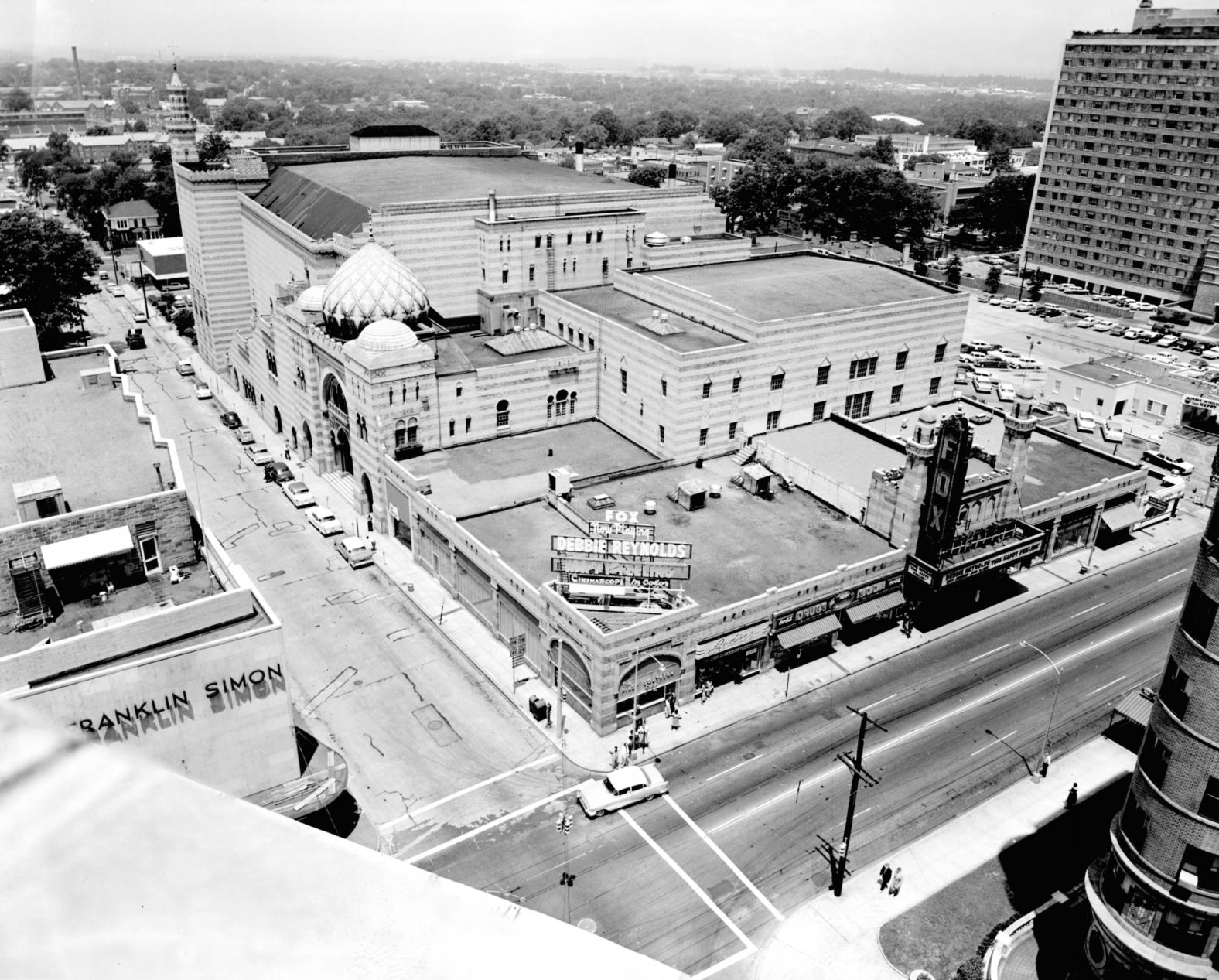 90 years after the city of Atlanta received the theatre as a Christmas gift, the Fox is one of the last-standing atmospheric theatres in the world. This is an aerial view of Atlanta in the late 1950's, when the film "This Happy Feeling" starring Debbie Reynolds was being featured at The Fox.