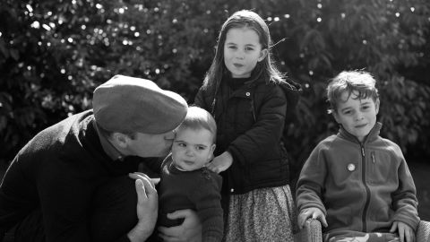 Prince William gives Prince Louis a peck on the cheek as Princess Charlotte and Prince George look on.