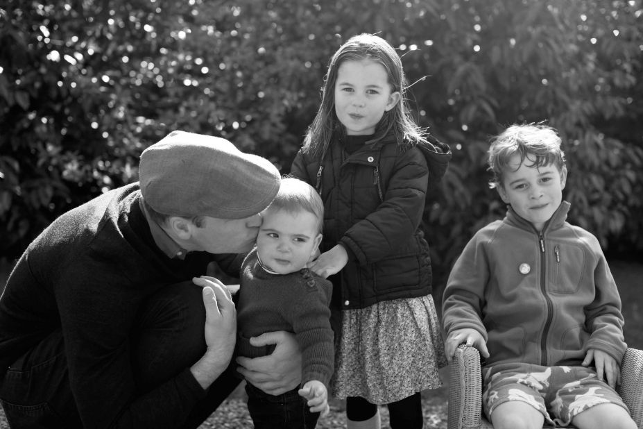 Prince William kisses his son Louis as they pose for a photo in Norfolk that was taken by Catherine in 2019.