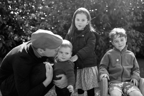 Prince William, Duke of Cambridge, kisses Prince Louis as they pose next to Princess Charlotte and Prince George in Norfolk in a handout photo taken by Catherine, Duchess of Cambridge, in 2019.