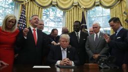 WASHINGTON, DC - SEPTEMBER 01:  U.S. President Donald Trump, Vice President Mike Pence and faith leaders say a prayer during the signing of a proclamation in the Oval Office of the White House September 1, 2017 in Washington, DC. President Trump signed a proclamation to declare this Sunday as a National Day of Prayer for people affected by Hurricane Harvey.  (Photo by Alex Wong/Getty Images)