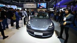 People watch Tesla Model 3 at Tesla booth on day three of the 2nd China International Import Expo (CIIE) at the National Exhibition and Convention Center on November 7, 2019 in Shanghai, China.