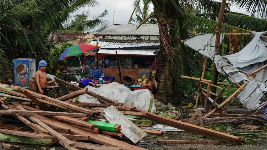 TOPSHOT - A resident looks at a house damaged at the height of Typhoon Phanfone in Tacloban, Leyte province in the central Philippines on December 25, 2019. - Typhoon Phanfone pummelled the central Philippines on Christmas Day, bringing a wet and miserable holiday season to millions in the mainly Catholic nation. (Photo by Bobbie ALOTA / AFP) (Photo by BOBBIE ALOTA/AFP via Getty Images)