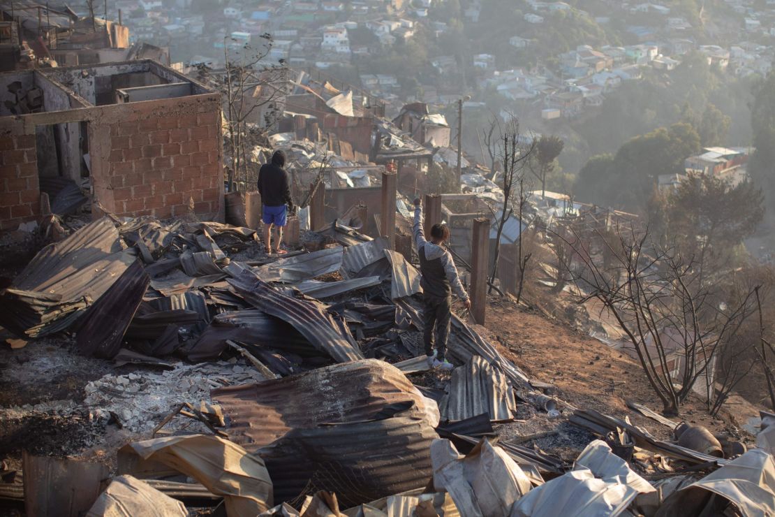 Residents look at the destruction caused by the fires in Valparaiso.