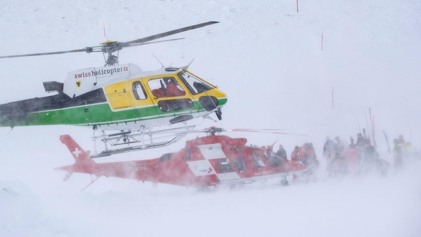 Rescue forces and helicopters search for missing people after an avalanche swept down a ski piste in the central town of Andermatt, canton Uri, Switzerland, Thursday, Dec. 26, 2019. The avalanche occurred mid-morning Thursday while many holiday skiers enjoyed mountain sunshine the day after Christmas. (Urs Flueeler/Keystone via AP)