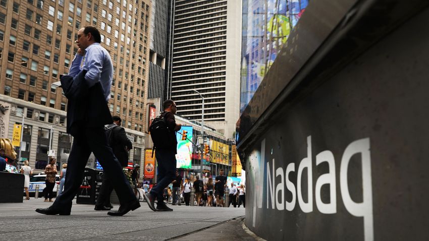 NEW YORK, NY - JULY 30:  People walk by the Nasdaq MarketSite in Times Square on July 30, 2018 in New York City. As technology stocks continued their slide on Monday, the Nasdaq Composite dropped 1.1 percent in afternoon trading with shares of Facebook, Netflix, Amazon and Google-parent Alphabet all declining.  (Photo by Spencer Platt/Getty Images)