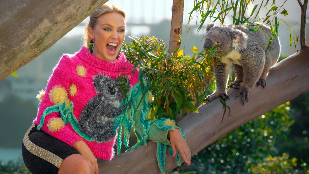 Kylie Minogue poses with a koala in a new Australian tourism ad.