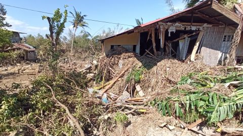 Debris from floods caused by Typhoon Phanfone surround a damaged house in Balasan Town, Iloilo province, on December 26, 2019.