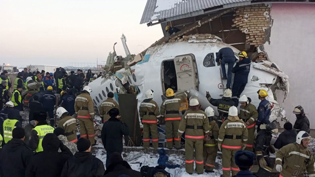 Police and rescue workers arrive at the site of the crash near Almaty International Airport, Kazakhstan, Friday, December 27, 2019.