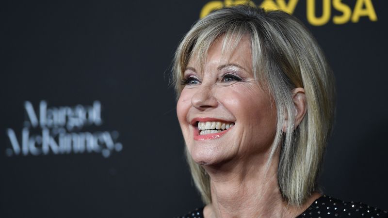 NextImg:Olivia Newton-John's husband and daughter say she's visited them as a 'blue orb' since dying | CNN
