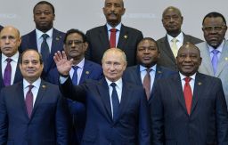 Russian President Vladimir Putin (C) gestures as Egypt's President Abdel Fattah al-Sisi (L) and South African President Cyril Ramaphosa (R) pose for a family photo with African countries leaders attending 2019 Russia-Africa Summit and Economic Forum in Sochi on October 24, 2019.