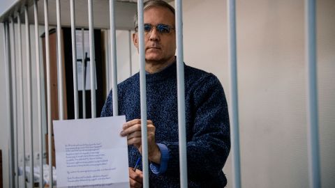 Paul Whelan, a former US Marine accused of espionage and arrested in Russia in December 2018, holds a message as he stands inside a defendants' cage before a hearing in October 2019.
