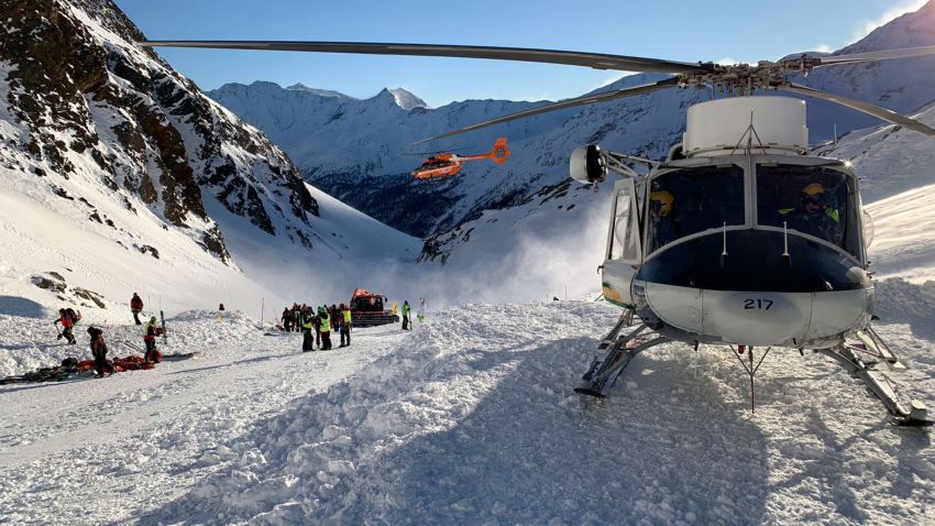 Rescuers at work following an avalanche in Val Senales, Saturday, Dec. 28, 2019. An avalanche has killed a woman and a two children who were skiing on a glacier in the Italian Alps. An Alpine rescue corps spokesman says helicopters are searching for any other possible victims of Saturday's avalanche. (ANSA via AP)