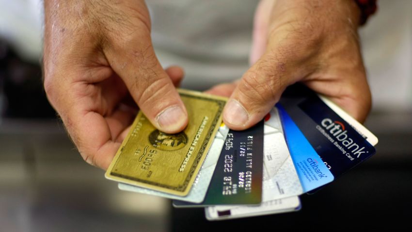 MIAMI - MAY 20:  Alain Filiz shows off some of his credit cards as he pays for items at Lorenzo's Italian Market on May 20, 2009 in Miami, Florida. Members of Congress today passed a bill placing new restrictions on companies that issues credit. The vote follows the Senate passage of the bill, which now heads for President Obama's promised signature. The bill will curb sudden interest rate increases and hidden fees, requiring card companies to tell customers of rate increases 45 days in advance. It will also make it harder for people aged below 21 to be issued credit cards.