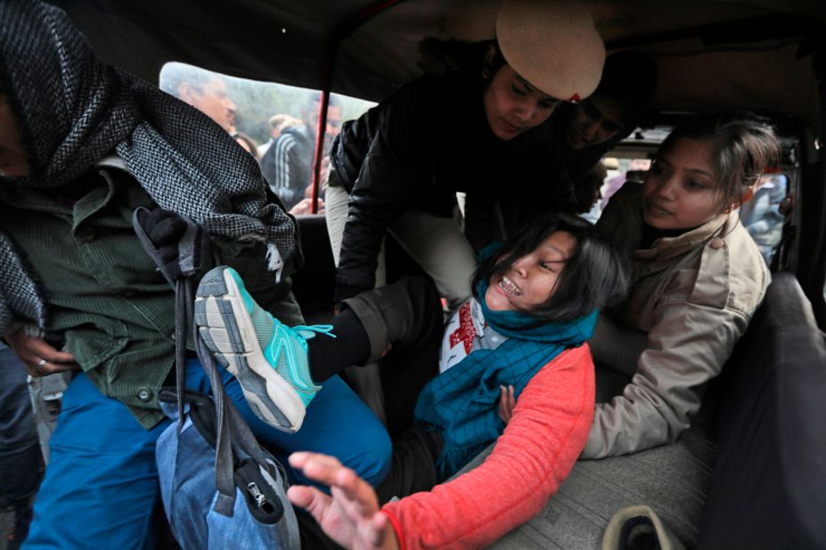 Policewomen detain a student protesting outside Uttar Pradesh Bhawan in New Delhi on Friday, December 27.