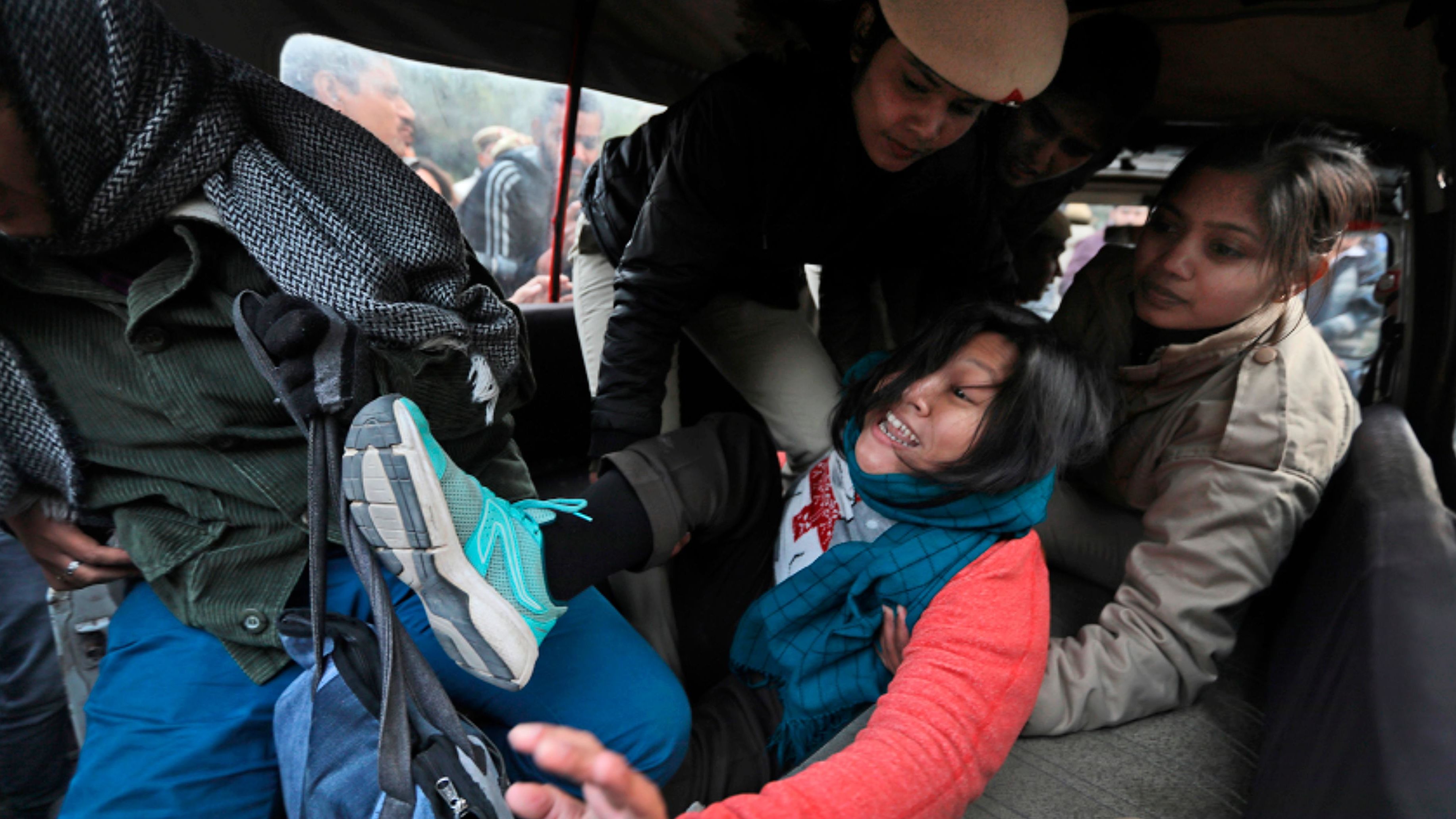 Policewomen detain a student protesting outside Uttar Pradesh Bhawan in New Delhi on Friday, December 27.